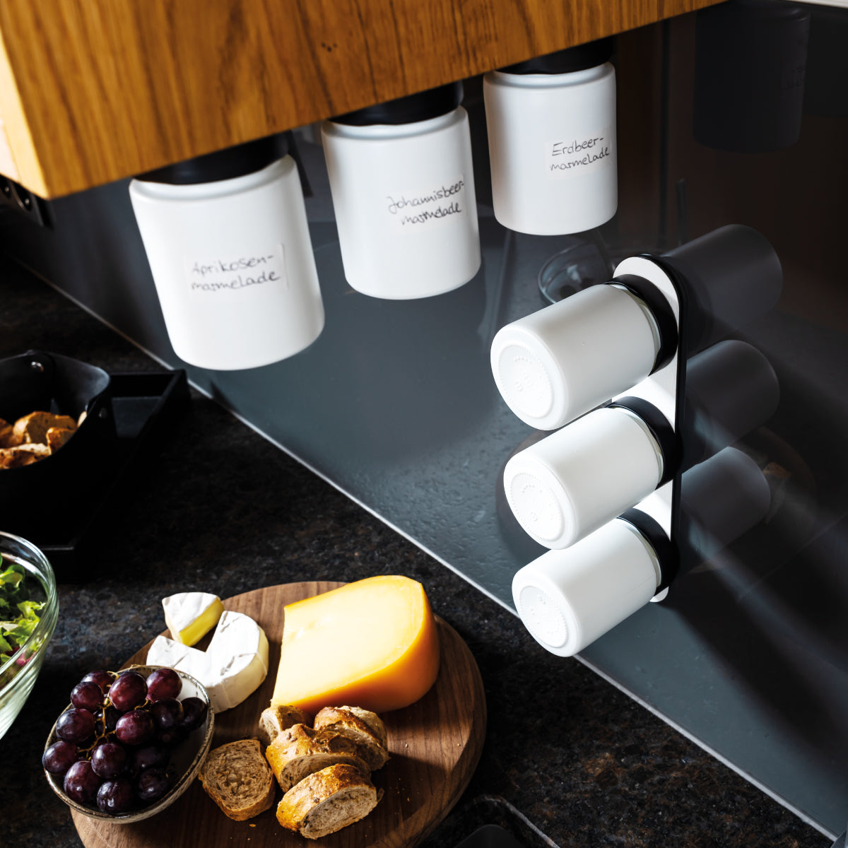 Magnet-Feinkostgläser an Metall-Leiste in Küchenumgebung montiert 